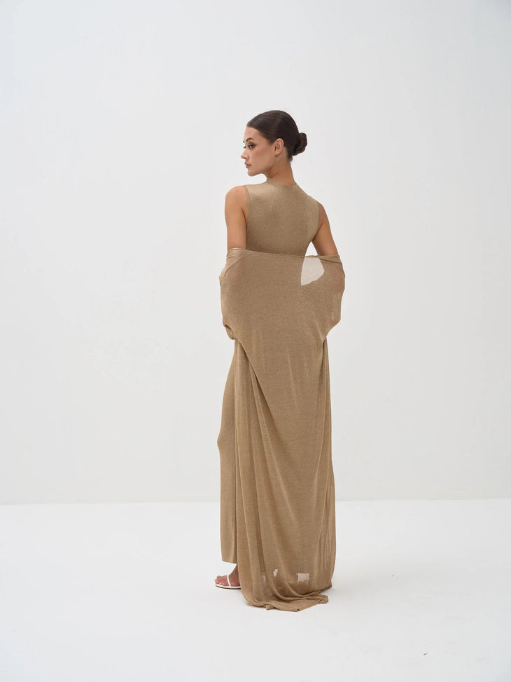 Elegant beige sleeveless bodysuit with matching draped shawl wrap, model shown from behind in minimalist setting — Nora The Label | Endless UAE