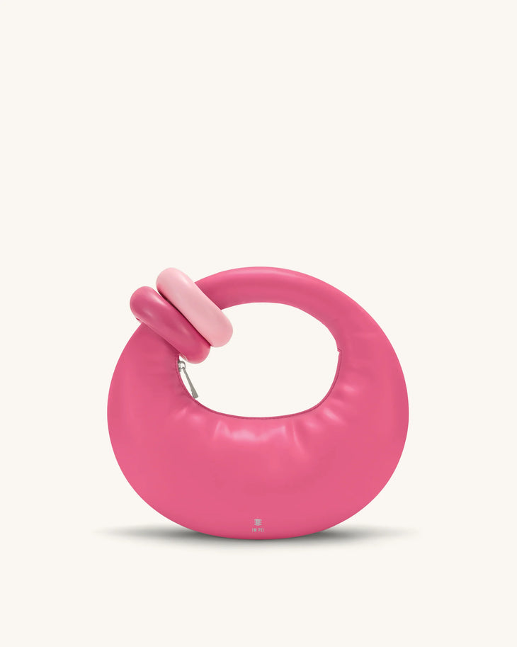 Pink circular handbag with unique tubular top handle detail and modern minimalist design — Jw Pei | Endless UAE