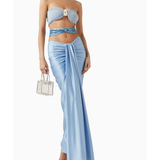 Woman wearing light blue Giselle Maxi Dress with cutout details and white handbag — Baobab | Endless UAE
