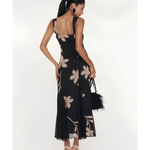 Woman wearing black Salima dress with white leaf embroidery and white shawl — Lady Pipa | Endless UAE
