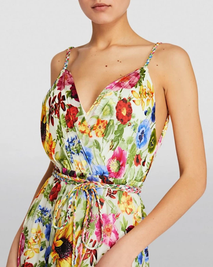 Woman wearing a colorful floral faux wrap maxi dress with sunflowers and pink flowers — Alice & Olivia | Endless UAE