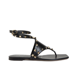 Valentino Garavani Rockstud black leather thong sandals with gold pyramid studs and ankle wrap strap — Valentino Garavani | Endless UAE