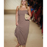 Model wearing brown geometric print strapless maxi dress with matching headscarf and woven clutch on runway — Monday Swimwear | Endless UAE