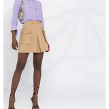 Beige pleated mini skirt with logo plaque and cargo pockets styled with lavender shirt — Elisabetta Franchi | Endless UAE