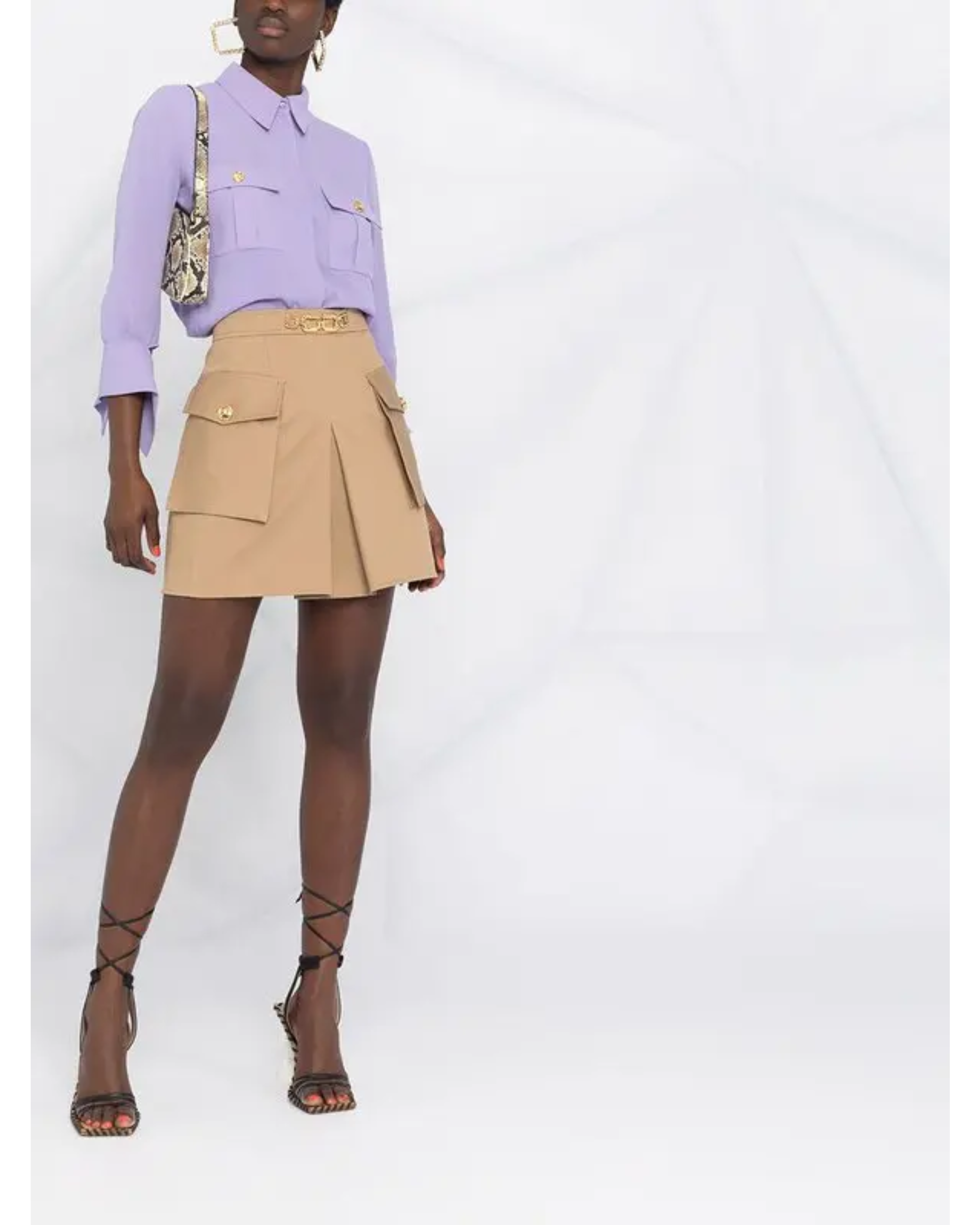 Beige pleated mini skirt with logo plaque and cargo pockets styled with lavender shirt — Elisabetta Franchi | Endless UAE