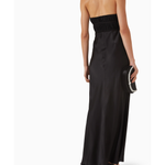 Woman wearing black halter maxi dress with ruched waist detail and silver accent — Misha | Endless UAE