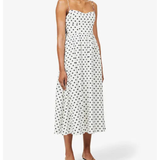 Woman wearing white polka-dot midi dress with spaghetti straps and black heels — Reformation | Endless UAE