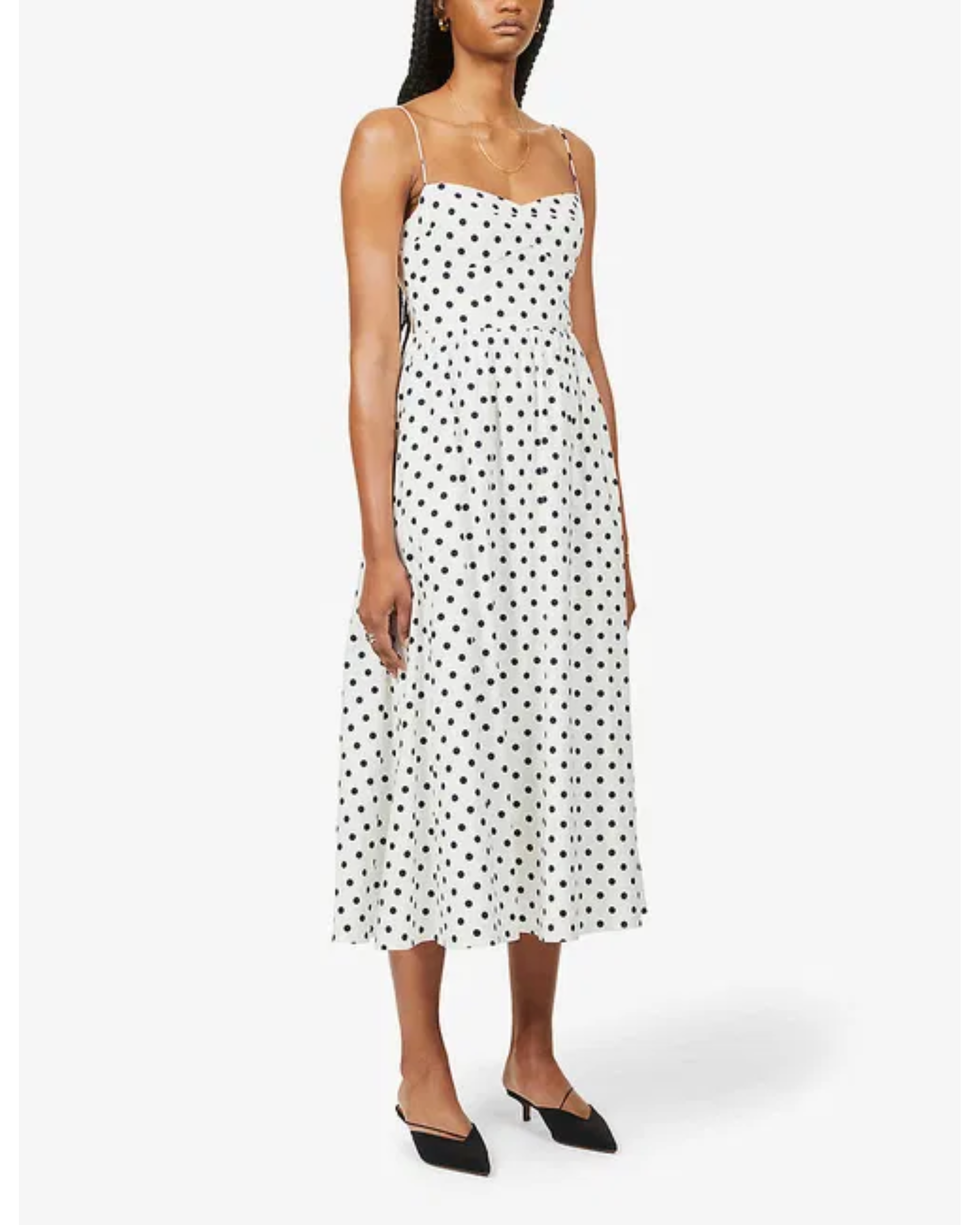 Woman wearing white polka-dot midi dress with spaghetti straps and black heels — Reformation | Endless UAE