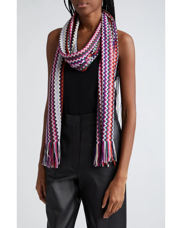 Multicolour zigzag knit scarf with fringe detail draped around neck on model wearing black outfit — Missoni | Endless UAE