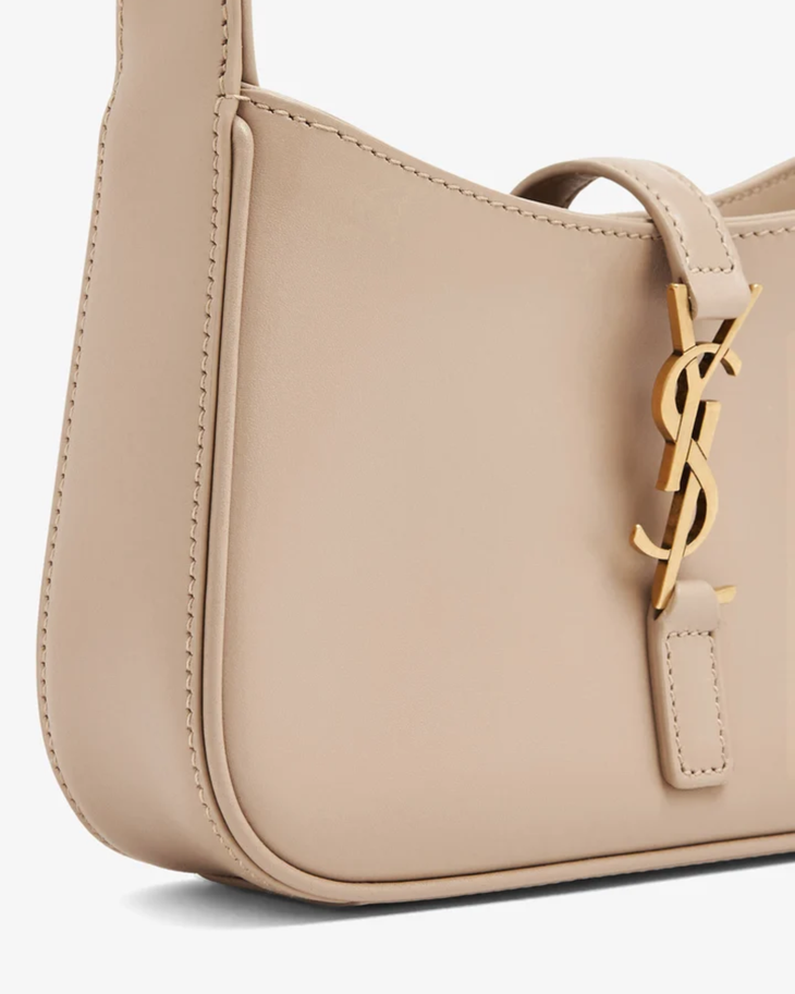 Beige leather mini hobo bag with gold YSL logo charm and contrast stitching — Yves Saint Laurent | Endless UAE