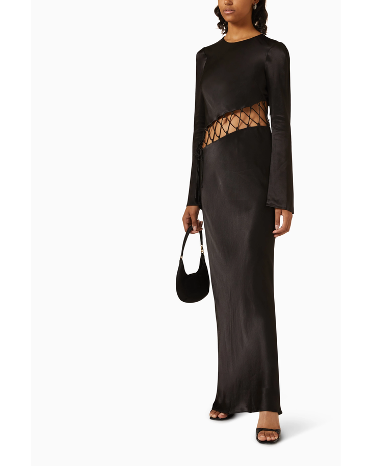 Black satin maxi dress with cutout waist detail and long sleeves on model with handbag — Shona Joy | Endless UAE