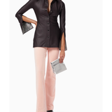 Black leather button-up shirt with crystal-embellished cuffs and split sleeves, styled with pink pants — Alexander Wang | Endless UAE
