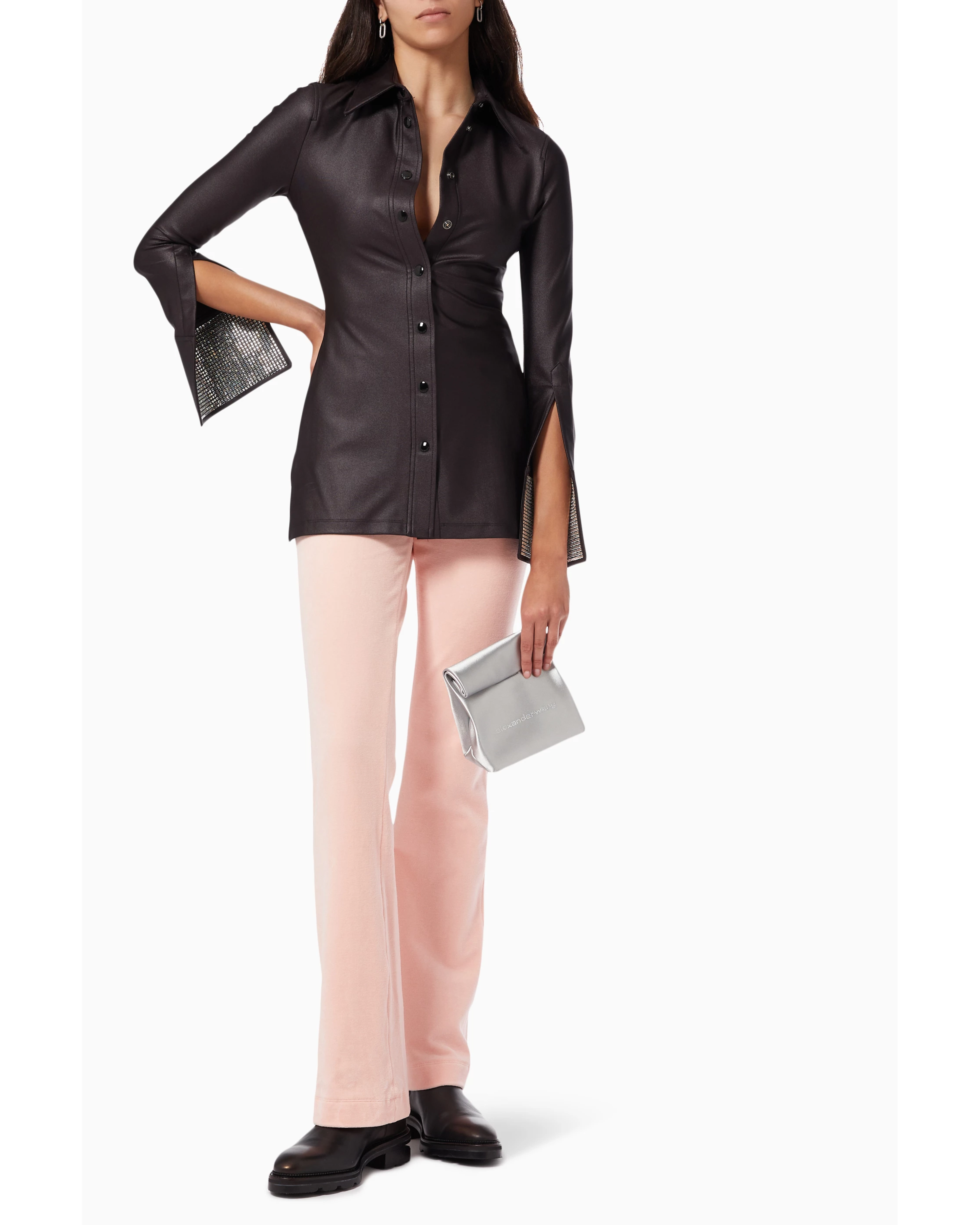 Black leather button-up shirt with crystal-embellished cuffs and split sleeves, styled with pink pants — Alexander Wang | Endless UAE