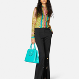 Woman wearing Barocco Goddess silk shirt in yellow with baroque print and colorful placket — Versace | Endless UAE