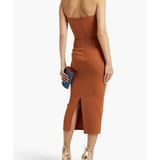 Woman modeling a rust-colored strapless stretch-crepe midi dress with strappy sandals — Alex Perry | Endless UAE