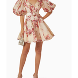 Woman wearing a cream linen mini dress with pink floral print, puff sleeves, and belted waist — ZIMMERMANN | Endless UAE