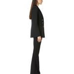 Woman in black double-breasted blazer with shawl lapel and flared pants, side view — Elisabetta Franchi | Endless UAE