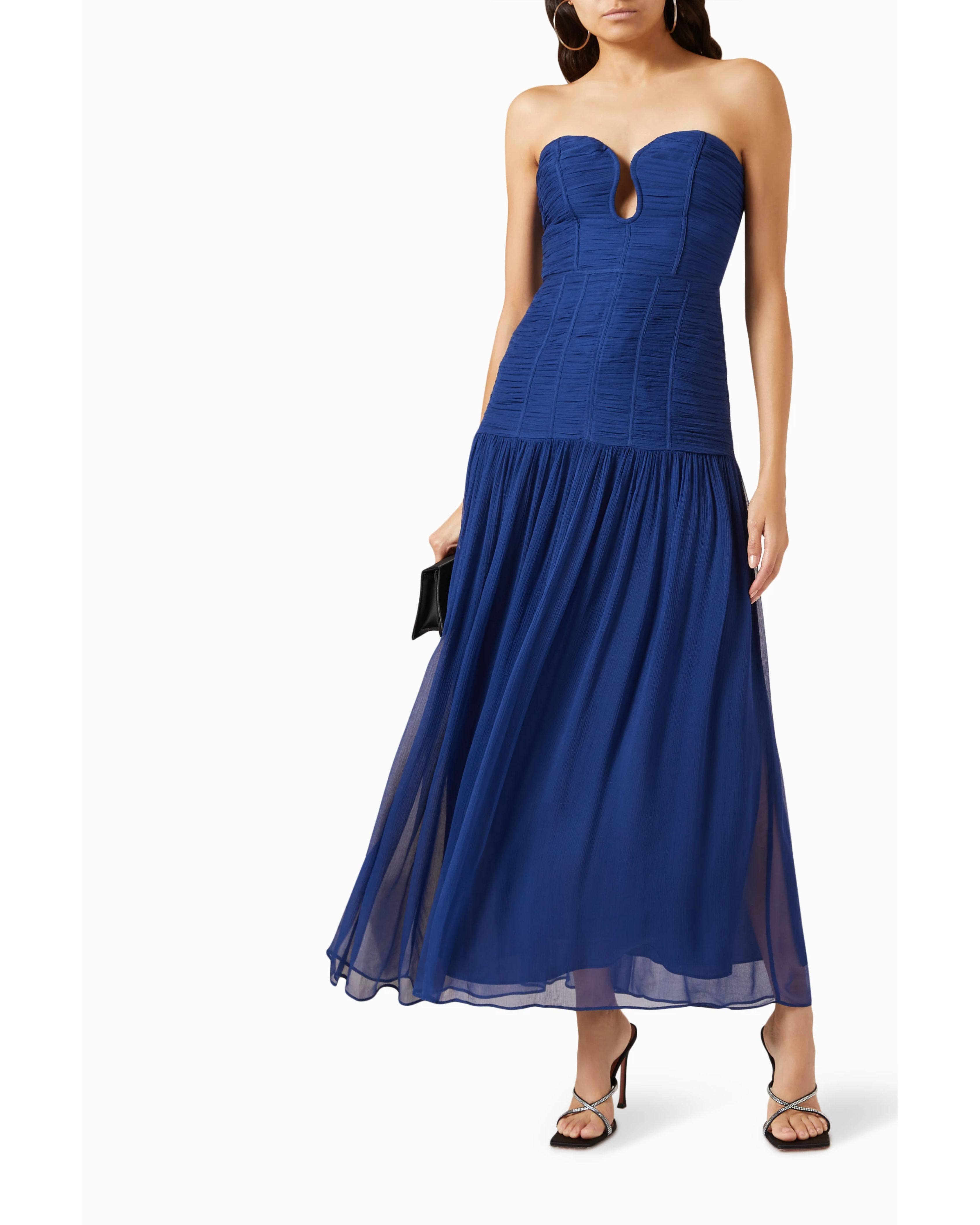 Woman wearing Isola Strapless Ruched Midi Dress in blue with black sandals — Shona Joy | Endless UAE