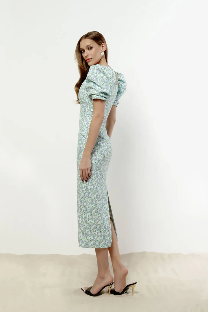 Light blue floral sequin midi dress with puff sleeves and side slit, paired with black heels — Post Meridiem | Endless UAE