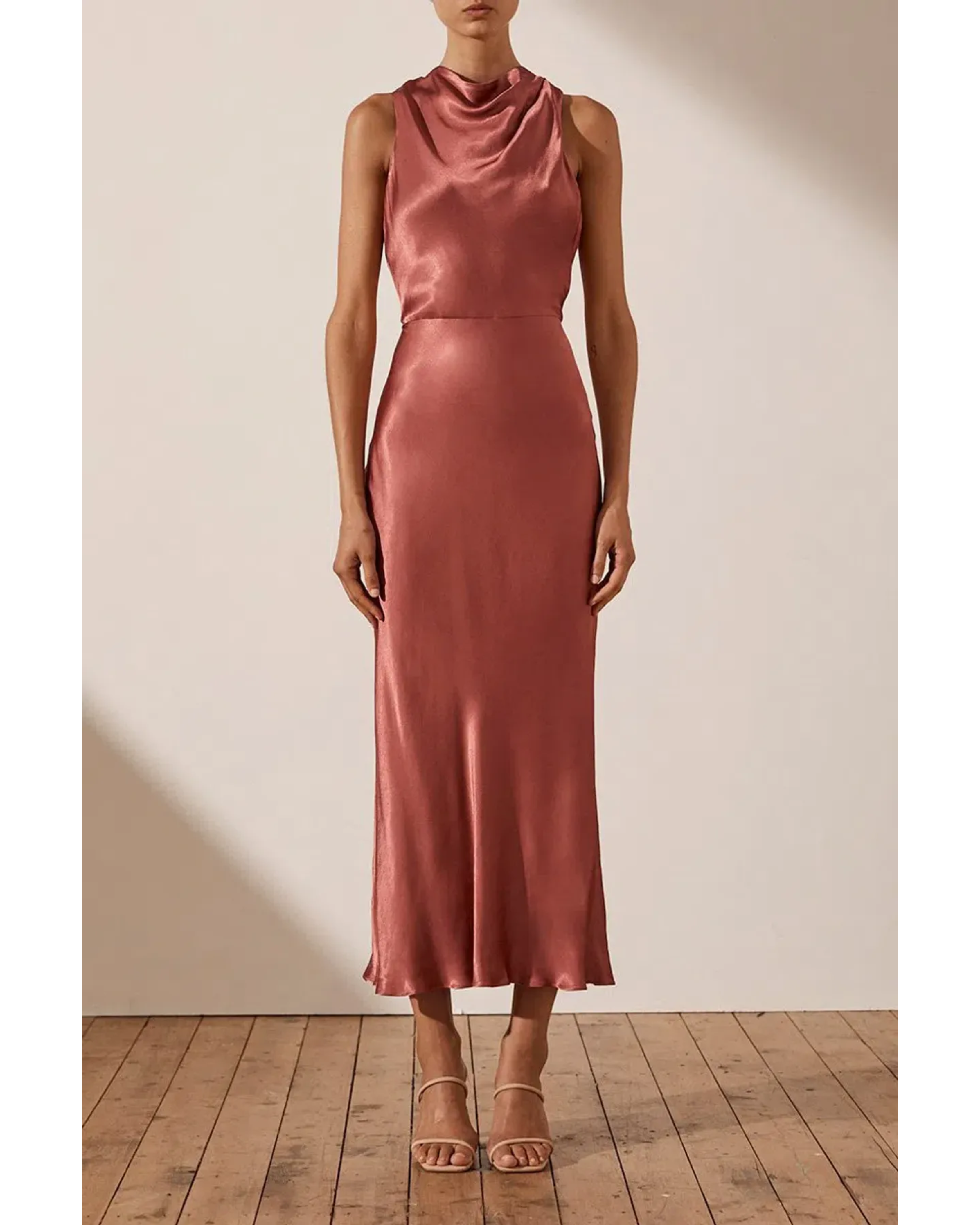 Woman wearing rust-colored high neck bias midi dress with strappy heels — Shona Joy | Endless UAE