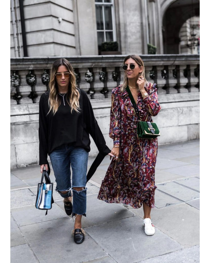 Woman wearing burgundy paisley maxi dress with white sneakers and sunglasses in urban setting — & Other Stories | Endless UAE