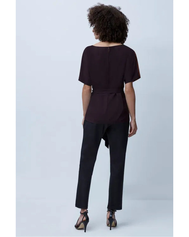 Woman wearing orange zebra stripe top with black sleeves and black cropped pants — French Connection | Endless UAE