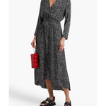 Woman wearing a black and white printed wrap midi dress with long sleeves, styled with black sandals and a red handbag — Maje | Endless UAE