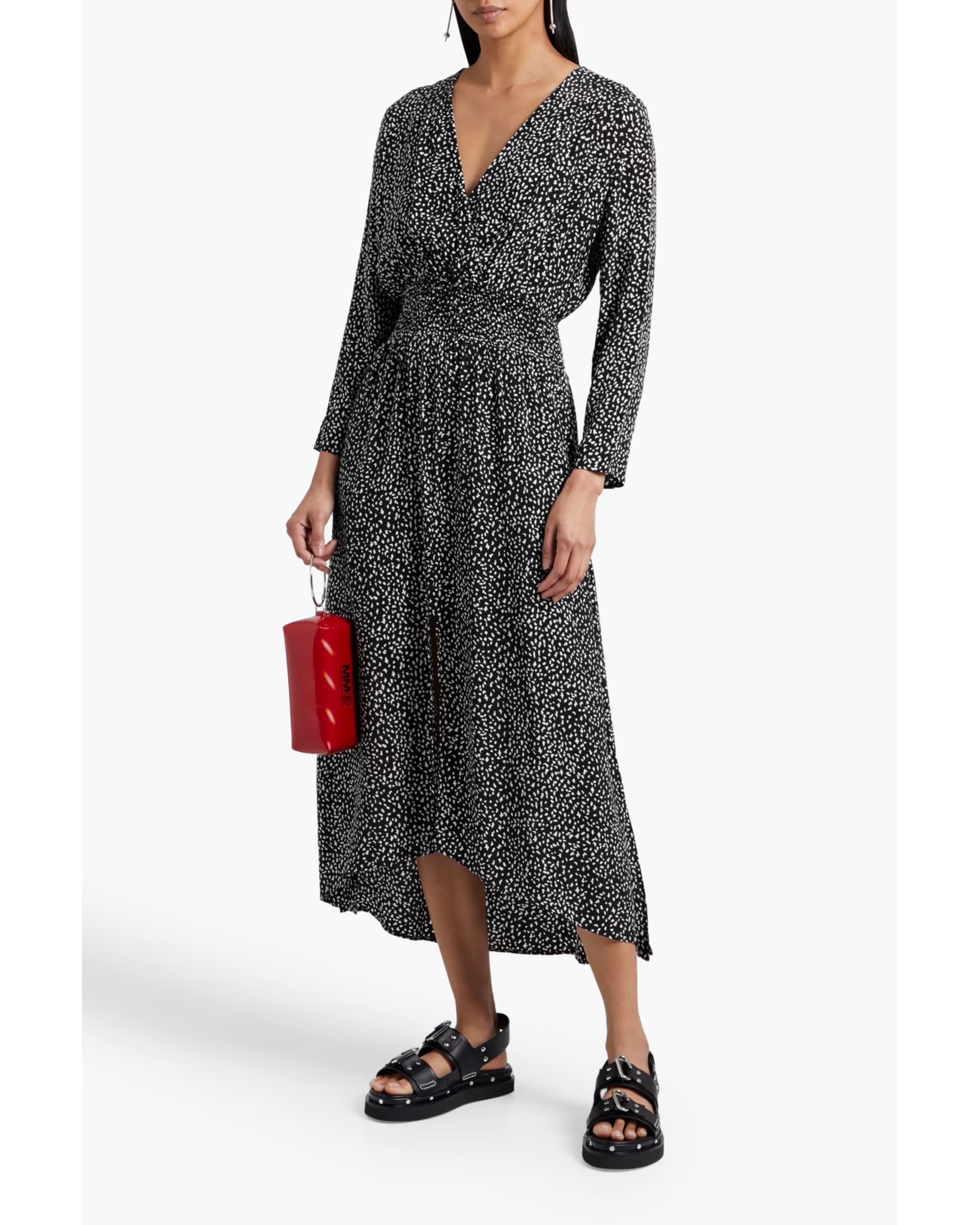 Woman wearing a black and white printed wrap midi dress with long sleeves, styled with black sandals and a red handbag — Maje | Endless UAE