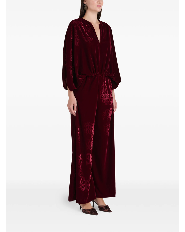 Woman wearing burgundy silk velvet jumpsuit with ornamental detailing and wide legs — Themis-Z | Endless UAE