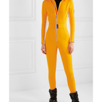 Bright yellow ski suit with belted waist and black turtleneck, paired with black skis — Cordova | Endless UAE