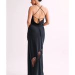 Woman wearing black satin maxi dress with lace side detail and halter neckline — Meshki | Endless UAE