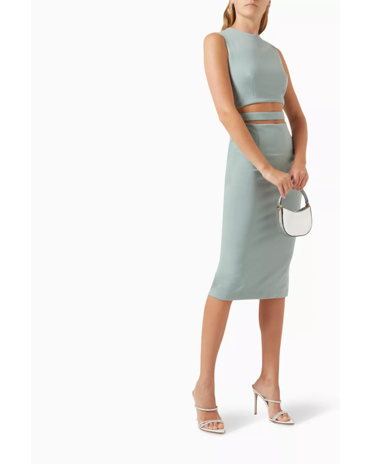 Woman wearing sage green sleeveless cut-out midi dress with white sandals — Elle Zeitoune | Endless UAE