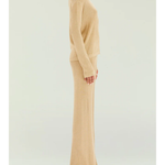 Woman wearing a beige metallic knit top and matching trousers holding a small handbag — SER.O.YA | Endless UAE