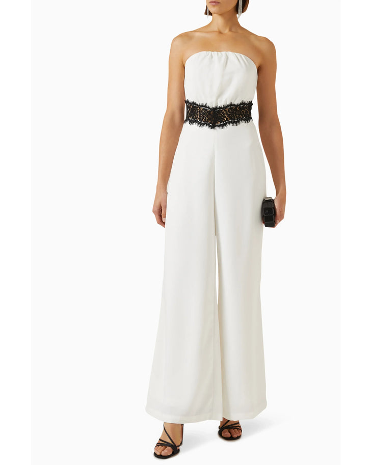Woman wearing cream strapless jumpsuit with black lace waistband — Elle Zeitoune | Endless UAE