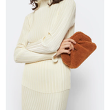 Gea Clutch in caramel brown textured fabric held in hand — TheMoire | Endless UAE
