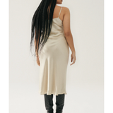 Woman wearing cream spaghetti strap slip dress with black strappy heels — Silk Laundry | Endless UAE