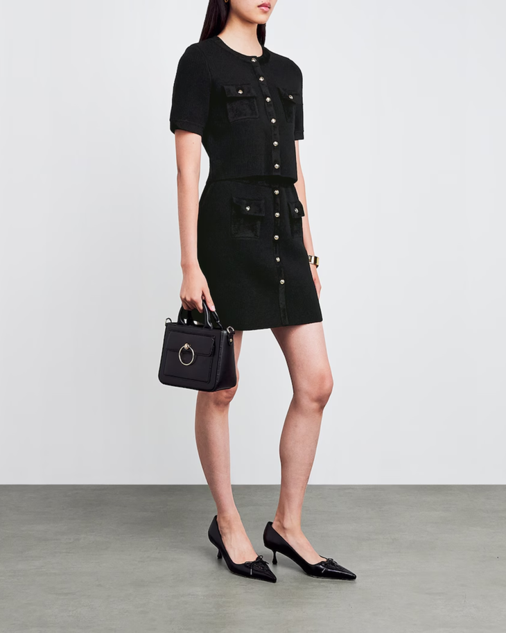 Black knitted mini skirt with button-down front and patch pockets styled with matching cardigan and heels — Claudie Pierlot | Endless UAE