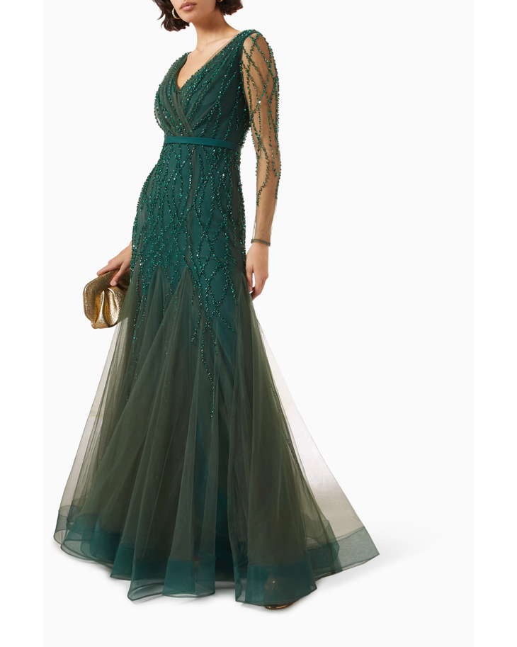 Elegant emerald green floor-length tulle gown with intricate sequin and bead embellishments, sheer long sleeves, and V-neckline — Basix | Endless UAE