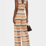Woman wearing a colorful striped cotton jumpsuit with orange, brown and cream zigzag pattern — Missoni | Endless UAE