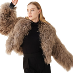 Woman wearing mocha fuzzy cropped jacket over black turtleneck and wide-leg trousers — Madame Magdalena | Endless UAE