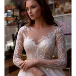 Elegant white wedding dress with beaded lace bodice and flowing ball gown skirt — Mar©a Anette | Endless UAE
