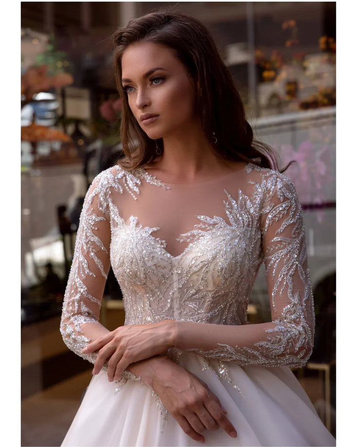 Elegant white wedding dress with beaded lace bodice and flowing ball gown skirt — Mar©a Anette | Endless UAE