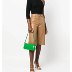 Dulce Patent Leather Shoulder Bag in vibrant green, held up against neutral background — By Far | Endless UAE