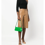 Dulce Patent Leather Shoulder Bag in vibrant green, held up against neutral background — By Far | Endless UAE