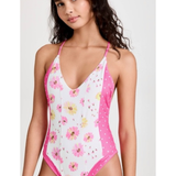 Pink floral one-piece swimsuit with white polka dot side panels and halter neck straps — LoveShackFancy | Endless UAE