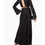 Black satin co-ord set with open back detail and flared sleeves, worn with heeled sandals — Significant Other | Endless UAE