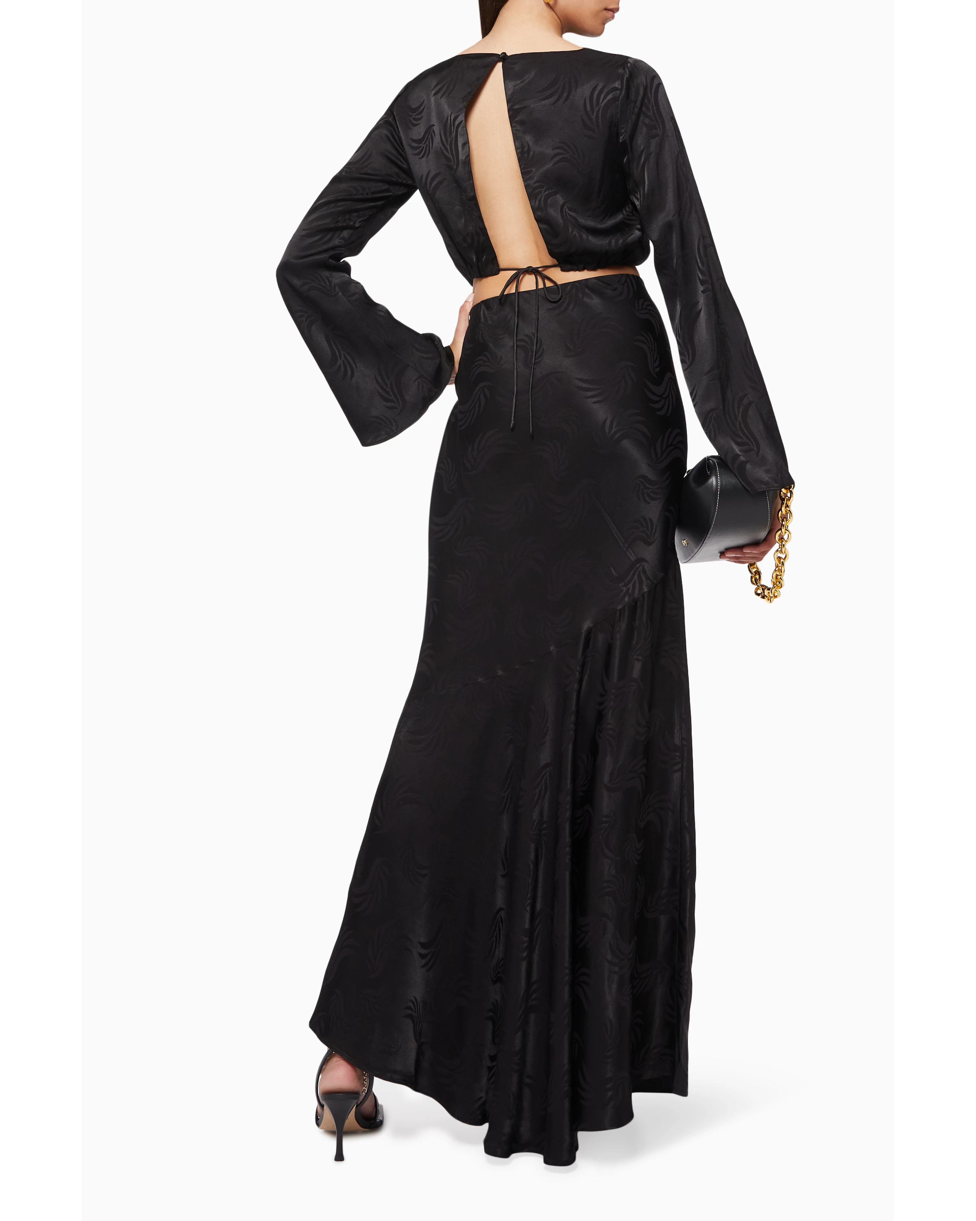 Black satin co-ord set with open back detail and flared sleeves, worn with heeled sandals — Significant Other | Endless UAE