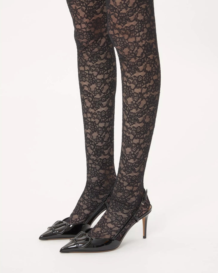 Black patent leather slingback pumps with Vlogo signature hardware and lace tights — Valentino Garavani | Endless UAE