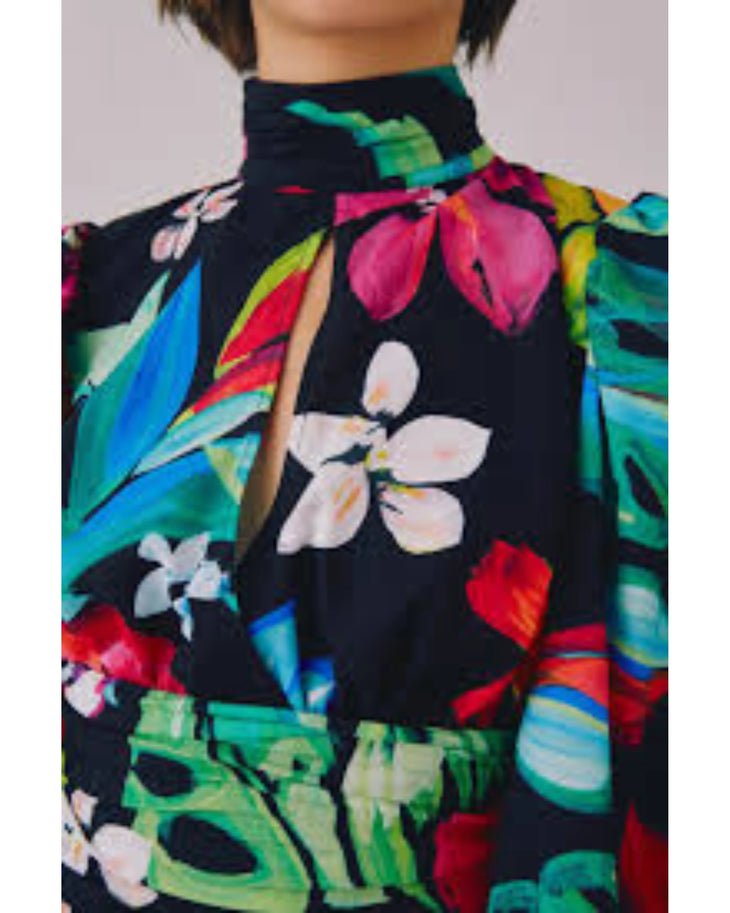 Woman wearing vibrant floral print wrap dress with puffed sleeves and turquoise slides — C/MEO Collective | Endless UAE