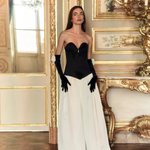Woman wearing black and white off-shoulder Parisienne Maxi Dress in ornate palace room — Lichi | Endless UAE